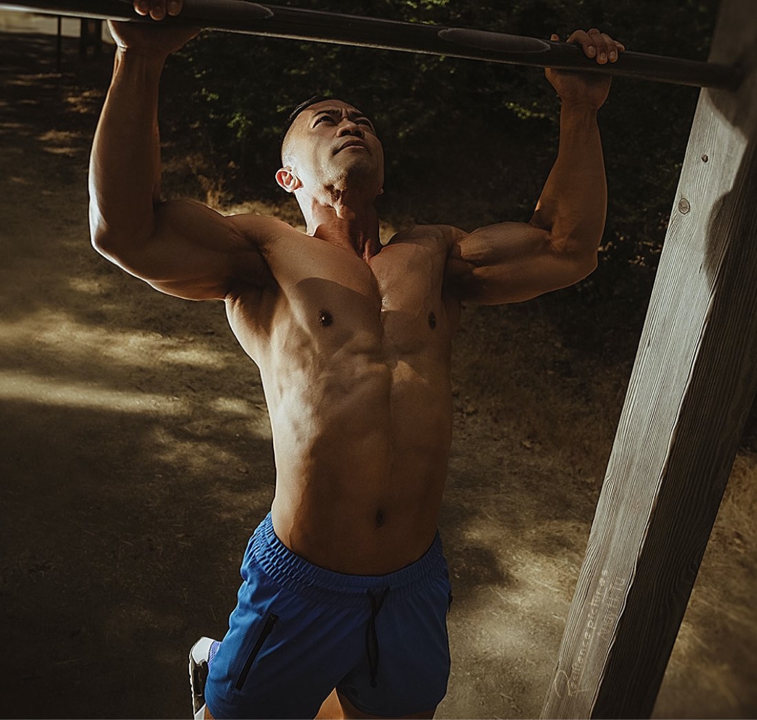 Gil Devera, male fitness model doing full pus outdoor in blue trunks